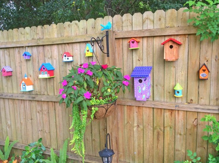 Colorful Birdhouses and Floral Fence Charm