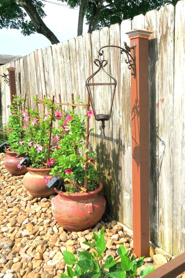 Elegant Fence with Hanging Lights and Flower Pots