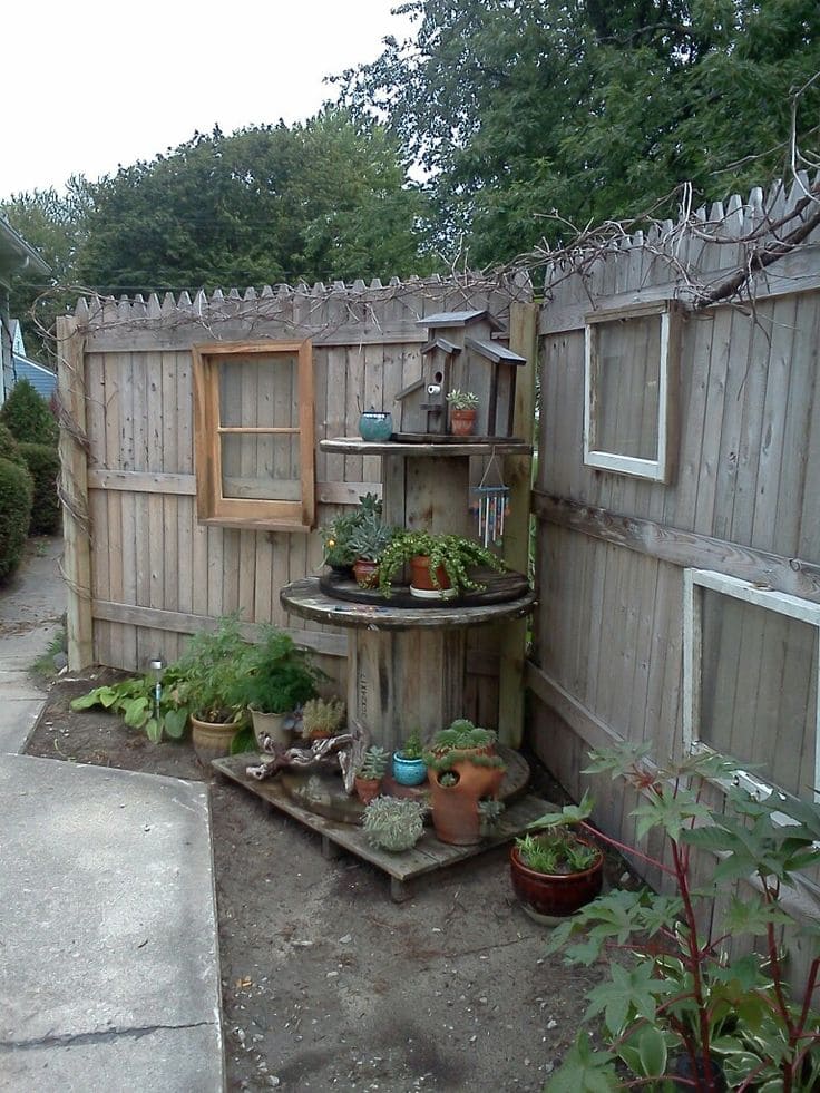 Tiered Plant Display and Birdhouse in Fence