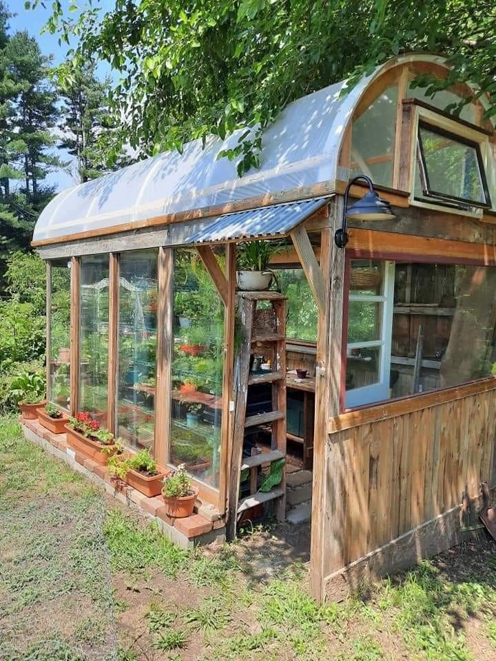 Cozy Curved-Roof Greenhouse with Rustic Touch