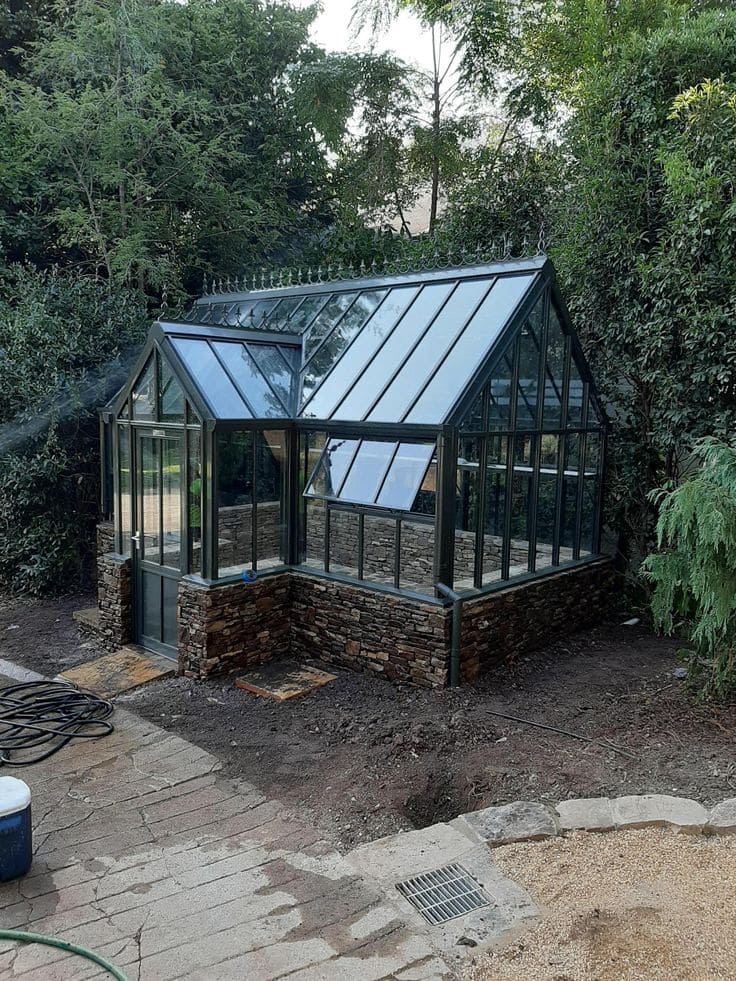 Elegant Stone-Base Greenhouse with Classic Charm