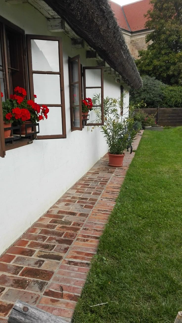 Charming Brick Pathway with Flowering Window Boxes Design